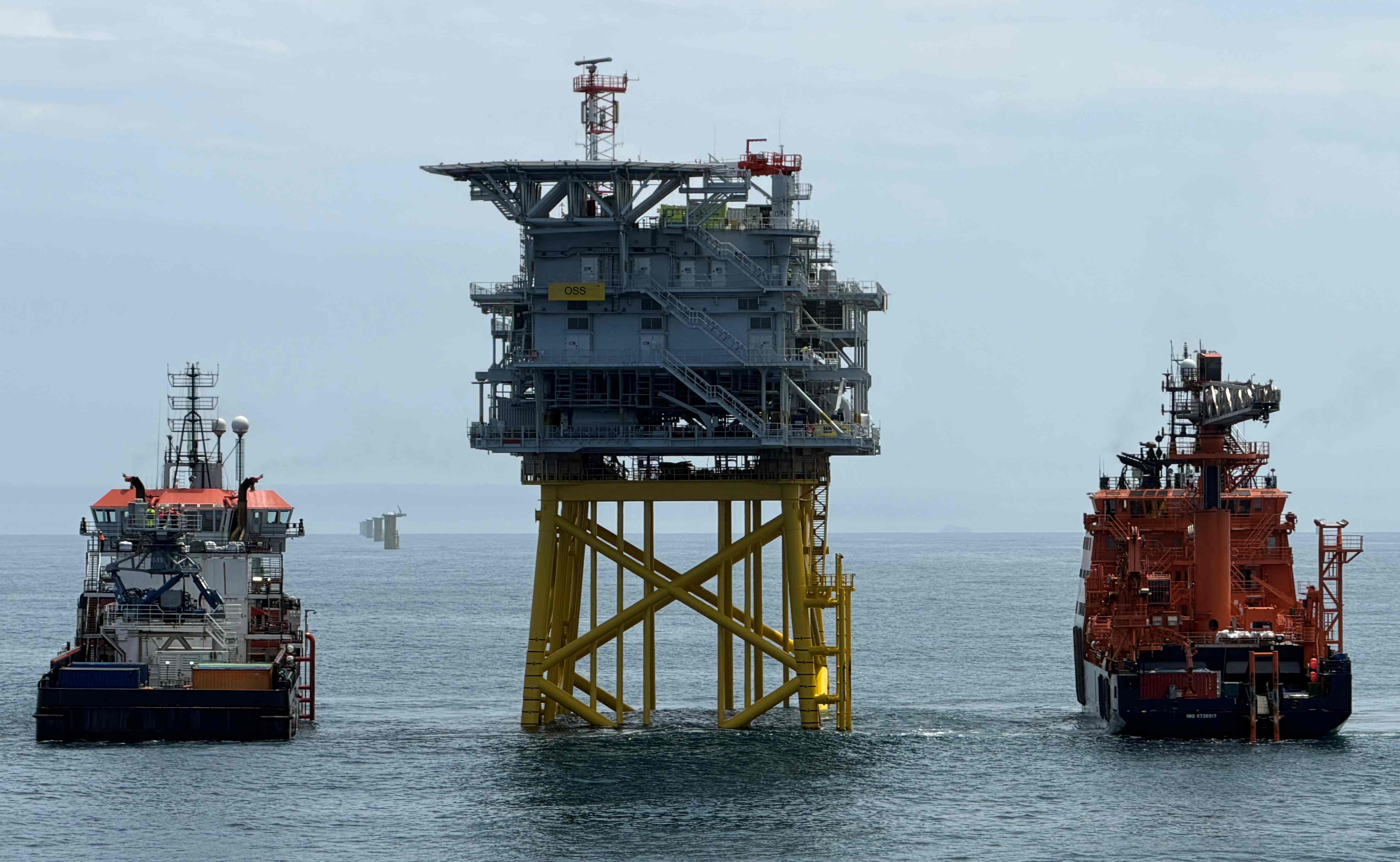 Two offshore vessels positioned around an offshore platform